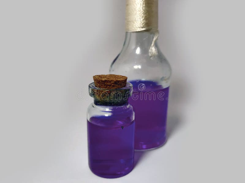Potions with violet liquid. Alchemy set with flasks. small glass bottles with colored liquid for game role play. magic potions stock photos