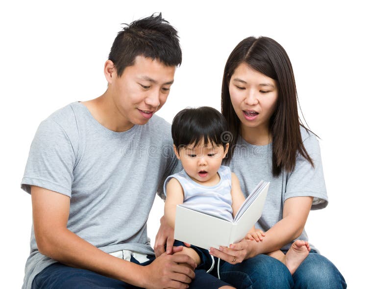 Young couple reading book with baby boy isolated on white. Young couple reading book with baby boy isolated on white