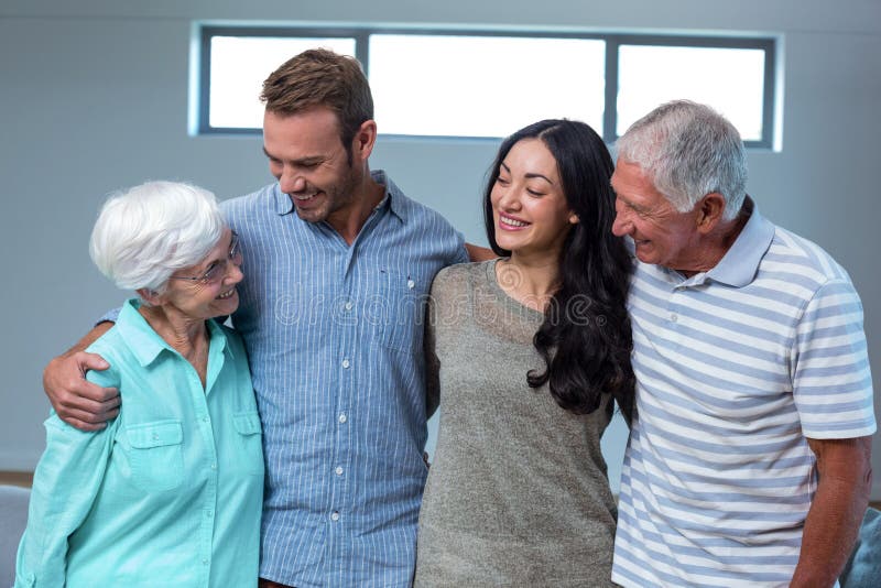 Young couple with their grandparents in living room. Young couple with their grandparents in living room