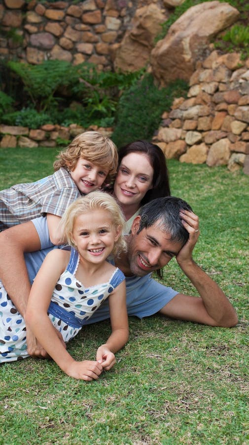 Potrait of a young family in the garden royalty free stock photography Potrait of a young family in the garden royalty free stock photography
