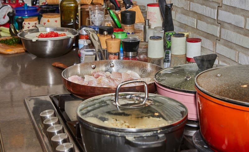 Pots with cooking food in the kitchen on gas stove stock photo