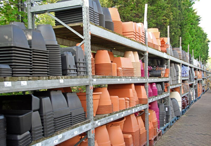 Photo of a nursery garden centre showing various colours and sizes of pots and containers for plants. may 2016. Photo of a nursery garden centre showing various colours and sizes of pots and containers for plants. may 2016.