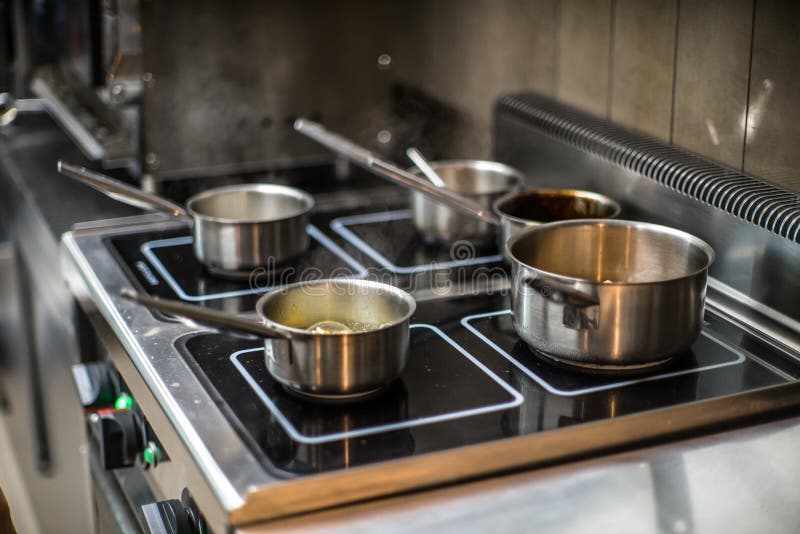 Pots on the Stove in the Restaurant. Cooking Food. Stock Photo Image