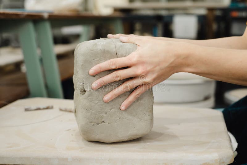 Top View of Potter Cutting Clay with Wire Cutter in Ceramic Studio