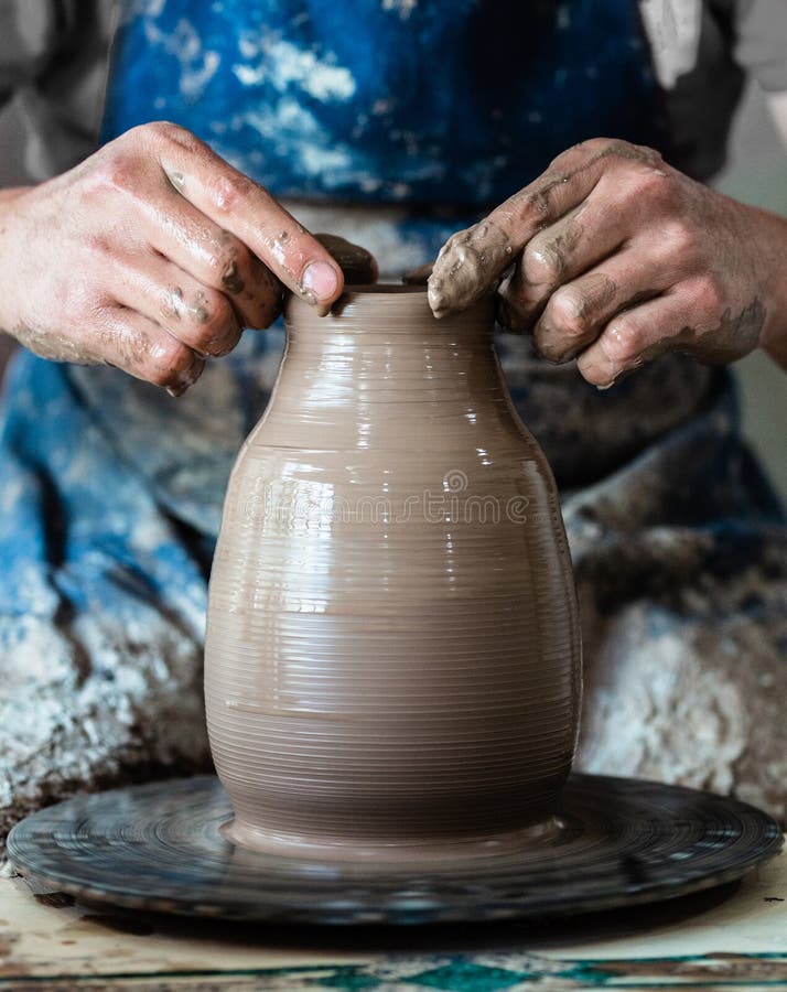 Potter Hands Making in Clay on Pottery Wheel. Potter Makes on the