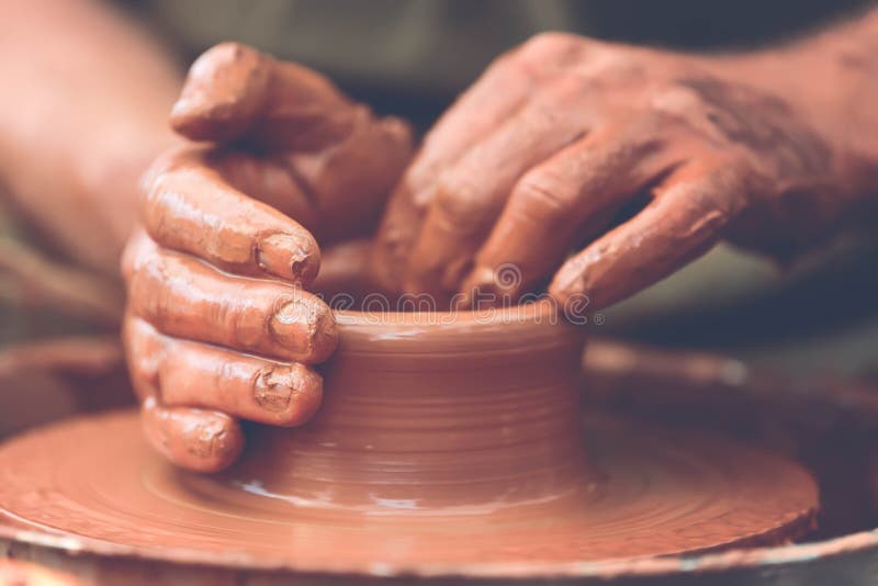 Hands of a potter. Potter making ceramic pot on the pottery wheel