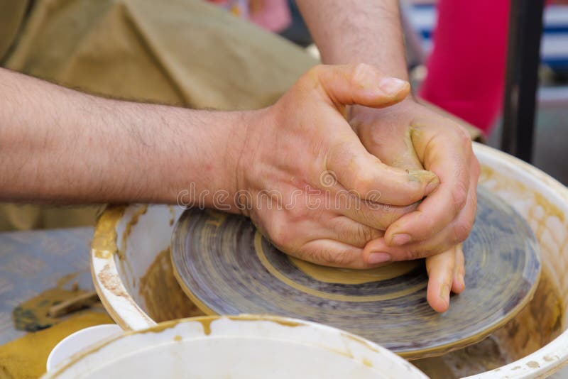 Potter in the Process of Working on a Potters Wheel. Closeup Hands