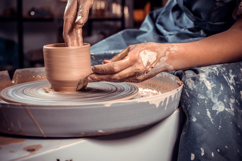 Hands of the Master Potter and Vase of Clay on the Potter& X27;s Wheel