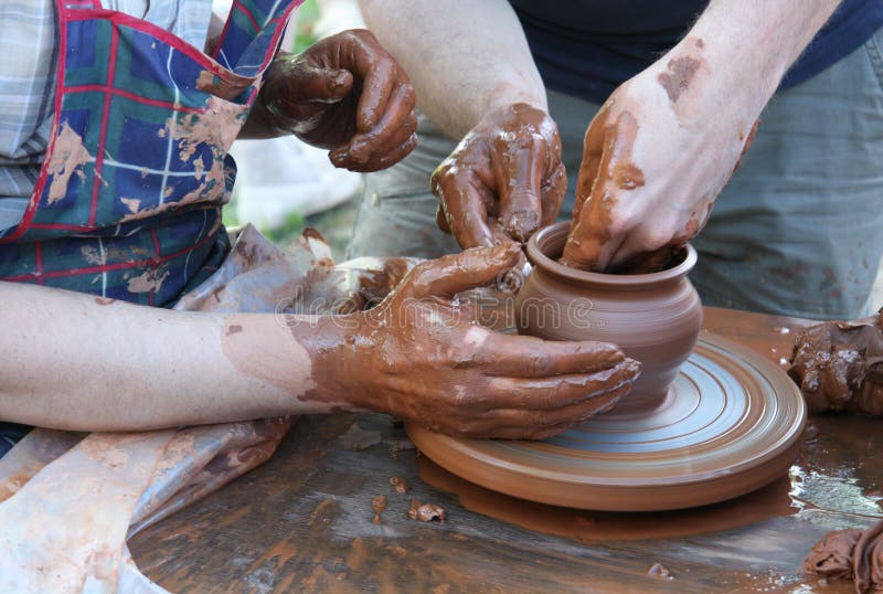 Potters hands creating a clay pot royalty free stock image