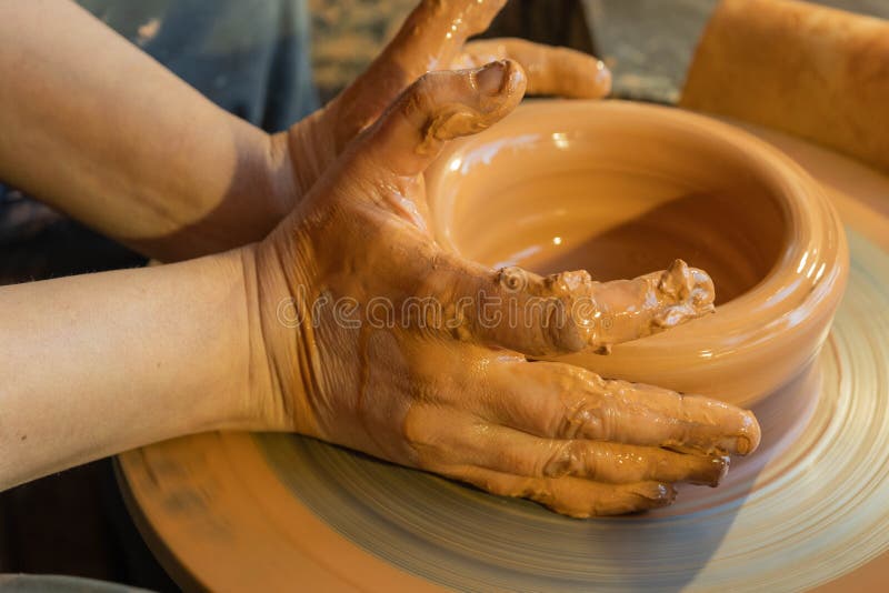 Potters Hands are Creating Earthenware on Potters Wheel. Concept of