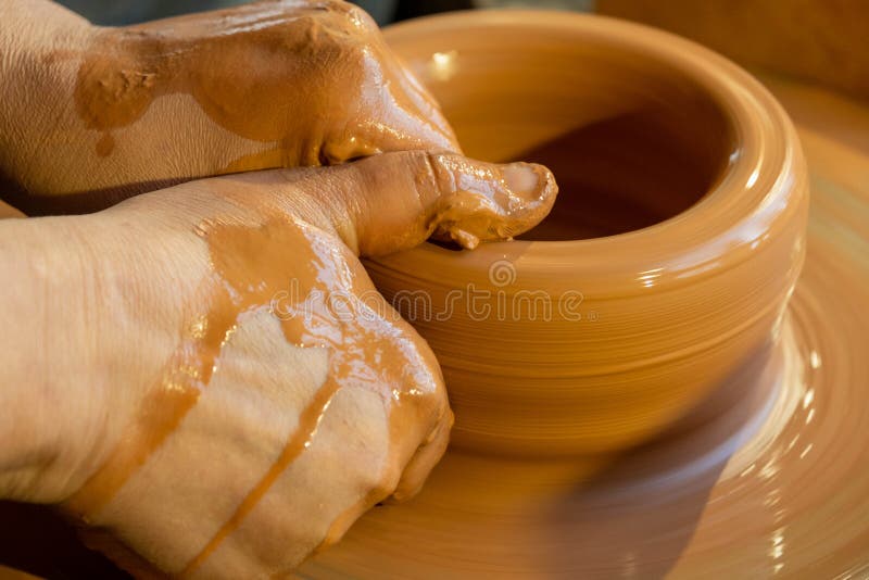 Potters Hands are Creating Earthenware on Potters Wheel. Concept of