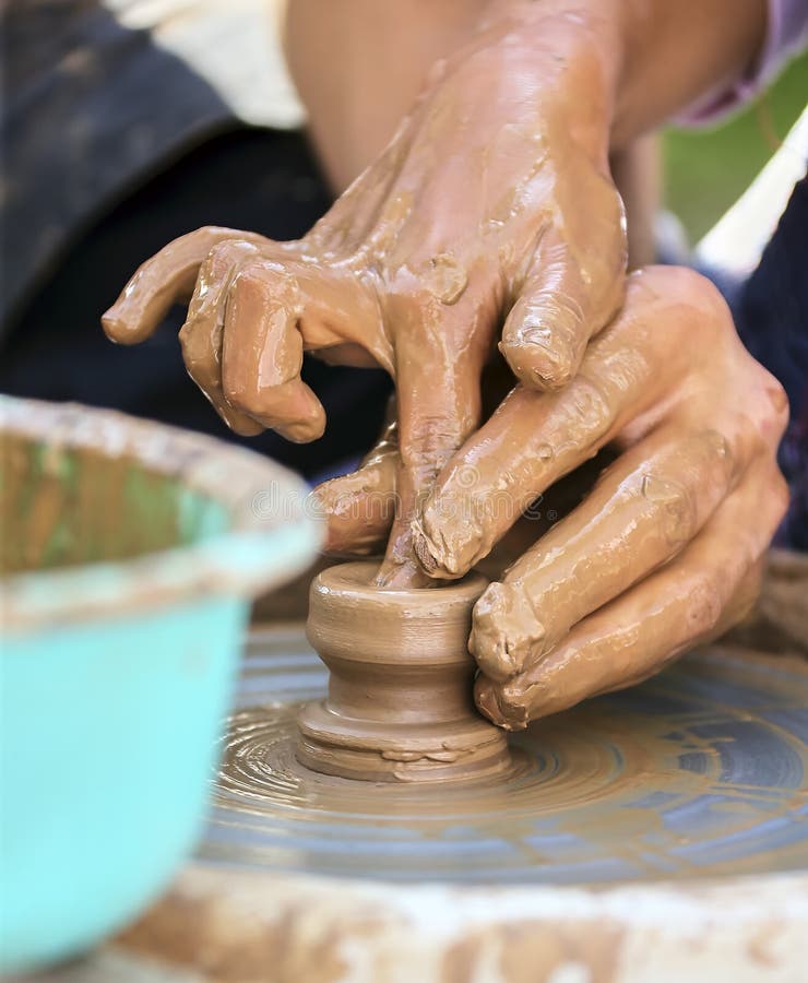 The Potters Hands are Gently and Surely Formed by a Clay Pot on a