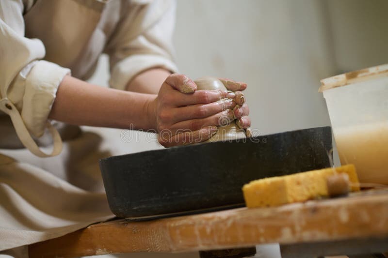 Close Up of Human Hands Molding Clay on a Pottery Wheel Stock Photo