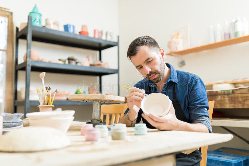 Pottery Expert Painting Bowl Made Of Clay royalty free stock photography