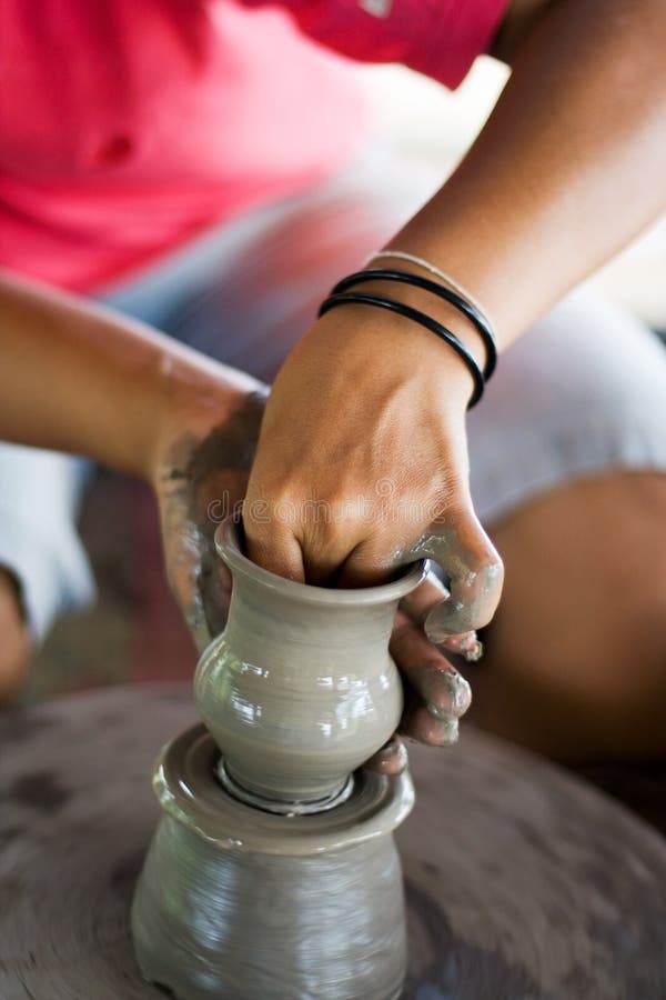 Female hands making pottery on spinning wheel. Female hands making pottery on spinning wheel