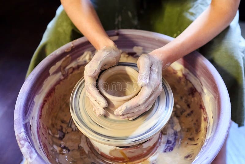 Pottery wheel.Occupation of art therapy. Making a pot of clay. Female hands