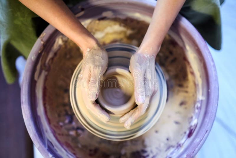 Pottery wheel.Occupation of art therapy. Making a pot of clay. Female hands