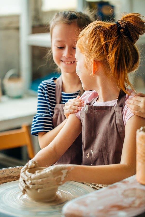 Pottery Girls Sculpts from Clay on Pottery Wheel Stock Image