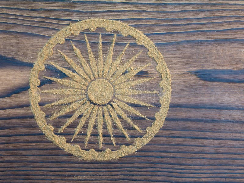 Indian henna powder in the form of Ashoka Chakra on the textured wooden board. Indian henna powder in the form of Ashoka Chakra on the textured wooden board