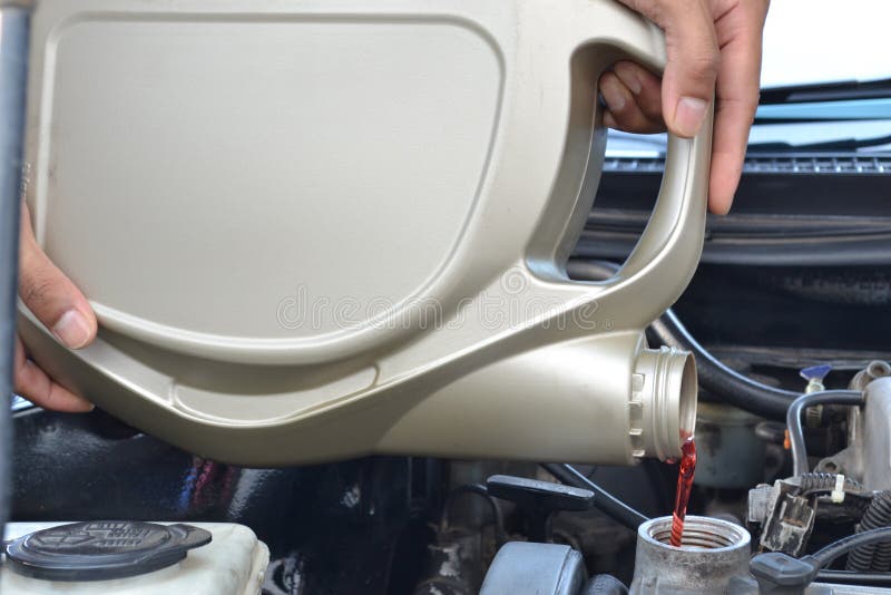 Car Mechanic Pouring Oil into Motor Engine Stock Photo Image of