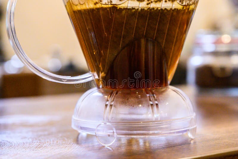 Pour over coffee brewing in clear dripper closeup royalty free stock image