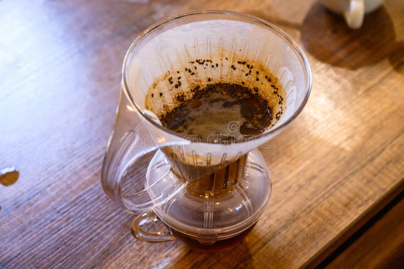 Pour over coffee brewing in glass dripper royalty free stock images