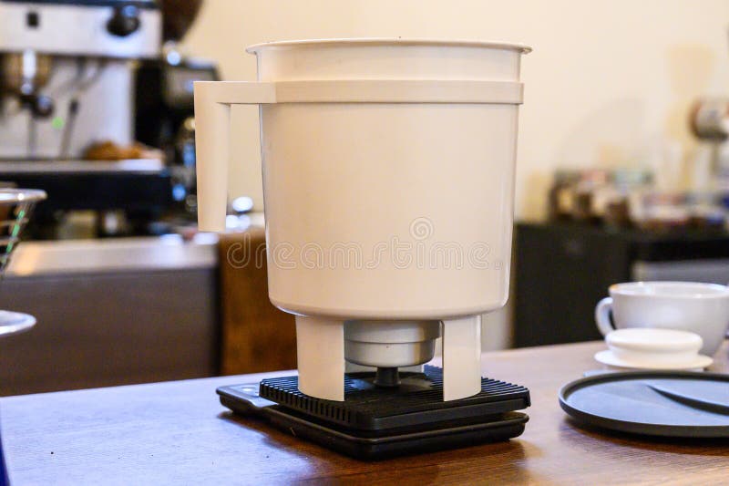 Pour over coffee brewing using a drip brewer device stock images