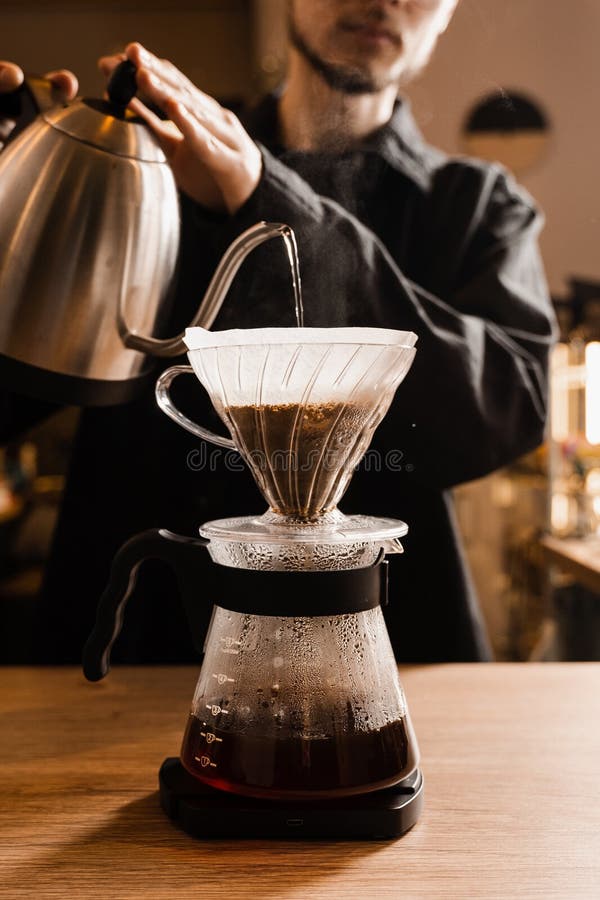 Premium Photo  Barista is boil water in syphon device for