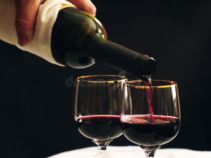 Is poured into wine glass red wine