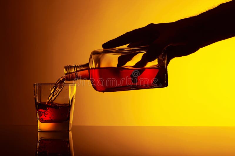 Pouring Alcoholic Drink from a Bottle into a Glass Stock Image Image