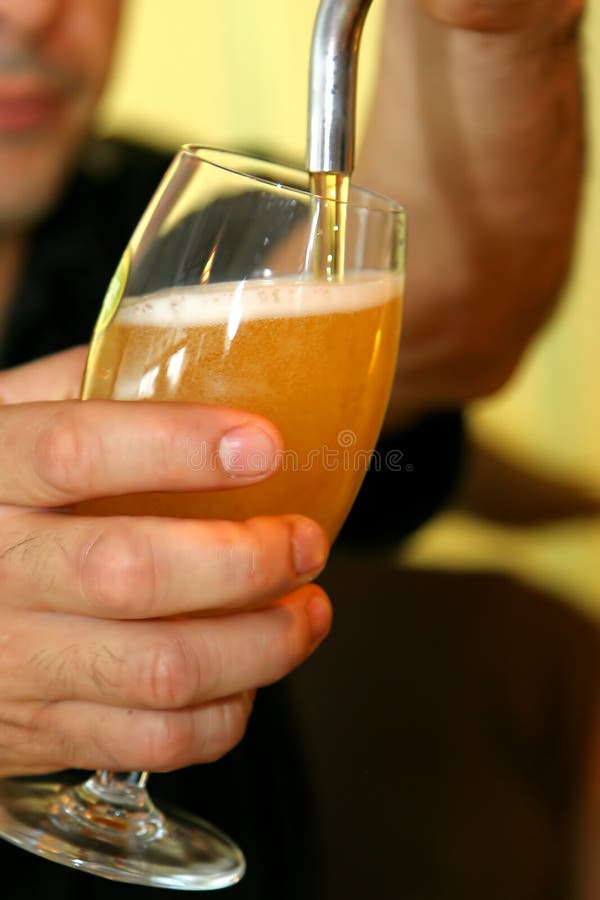 Pouring beer on a glass