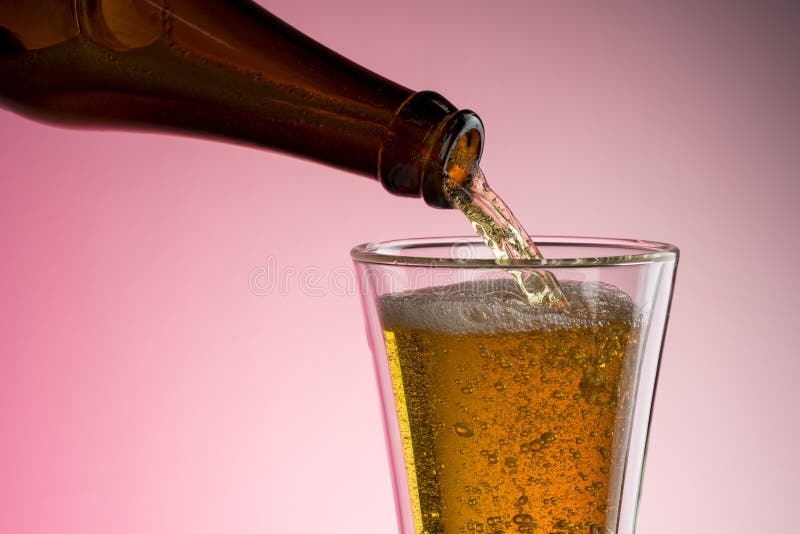 Pouring Beer Into Glass stock photography
