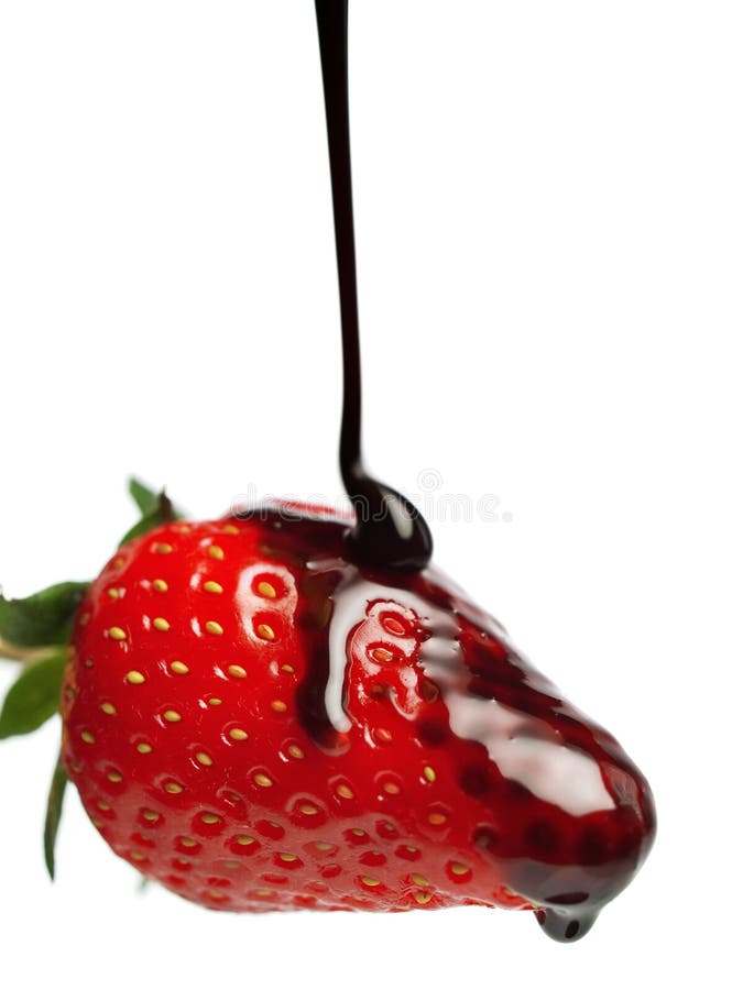 Pouring chocolate sauce on strawberry