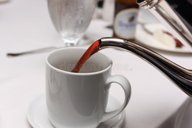 Pouring Coffee Into Overflowed White Porcelain Mug With Saucer. Cup