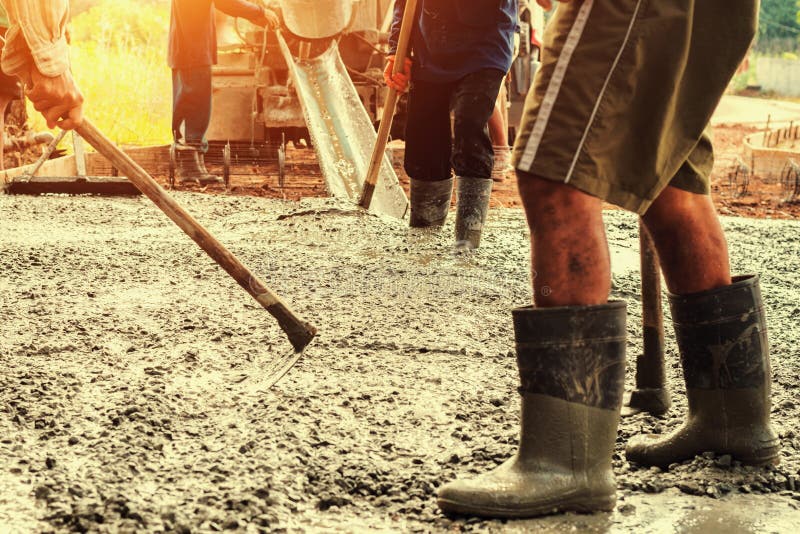 Pouring Concrete With Worker Mix Cement For Building Road At Con Stock