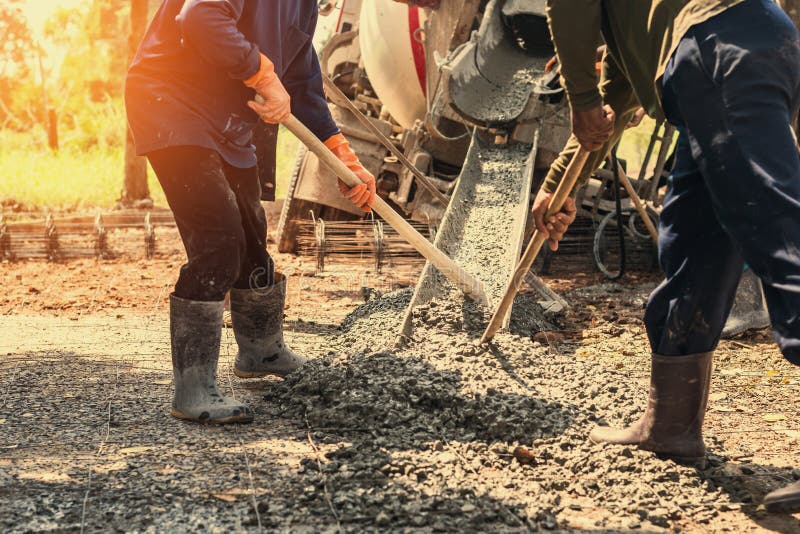 pouring concrete with worker mix cement at construction