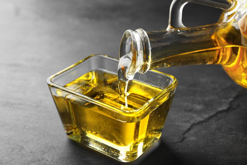 Pouring Cooking Oil from Jug into Bowl on Table Stock Photo Image of