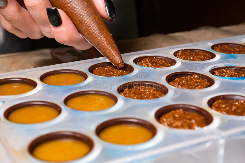 Pouring the Filling into Candies during the Manufacturing Process Stock