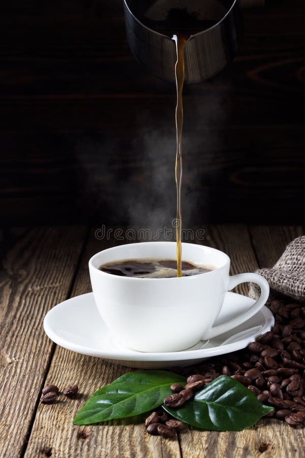 Pouring hot coffee in white cup royalty free stock images Pouring hot coffee in white cup royalty free stock images