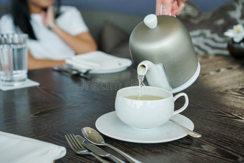 Pouring Hot tea into tea cup. royalty free stock image Pouring Hot tea into tea cup. royalty free stock image