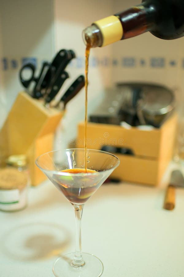 Pouring a Martini Glass in a Domestic Kitchen Stock Photo Image of
