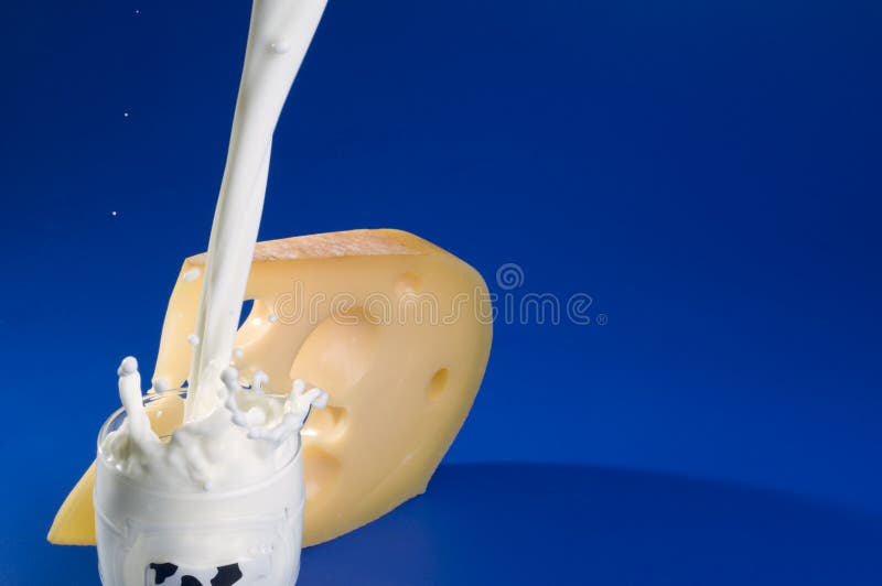 Pouring milk and cheese over blue background.