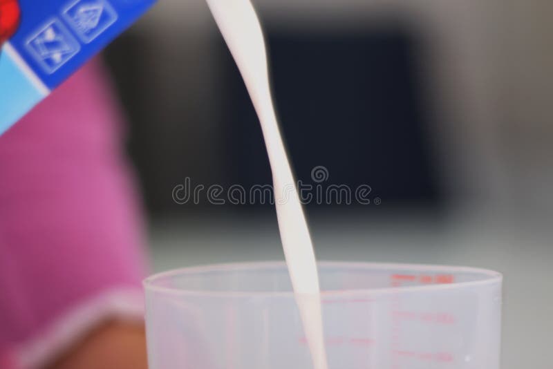 Pouring Milk into a Plastic Container Stock Photo Image of fresh