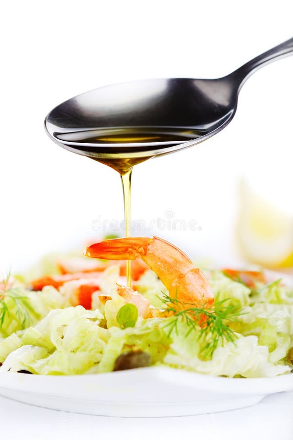 Pouring olive oil in the salad