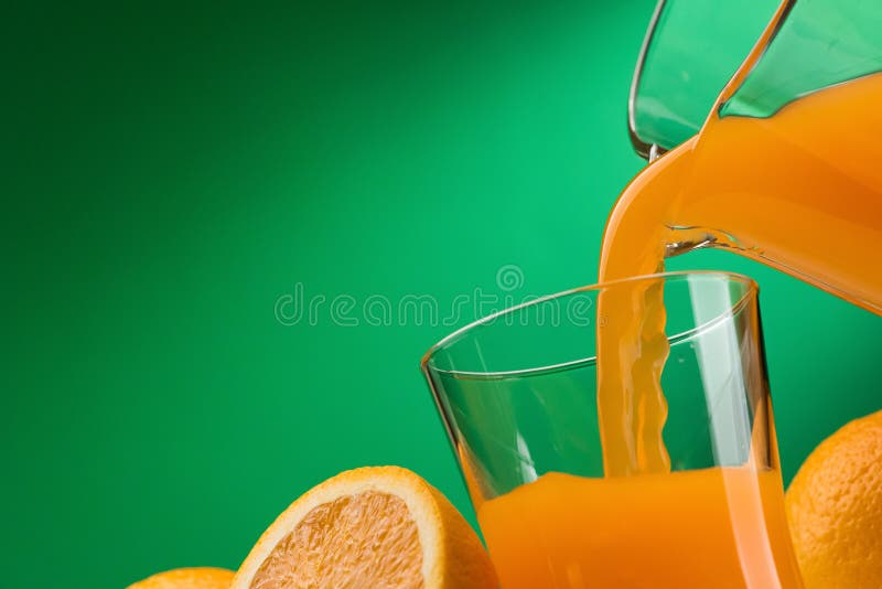 Pouring orange juice into a glass and sliced fresh oranges, vitamins and healthy drinks concept