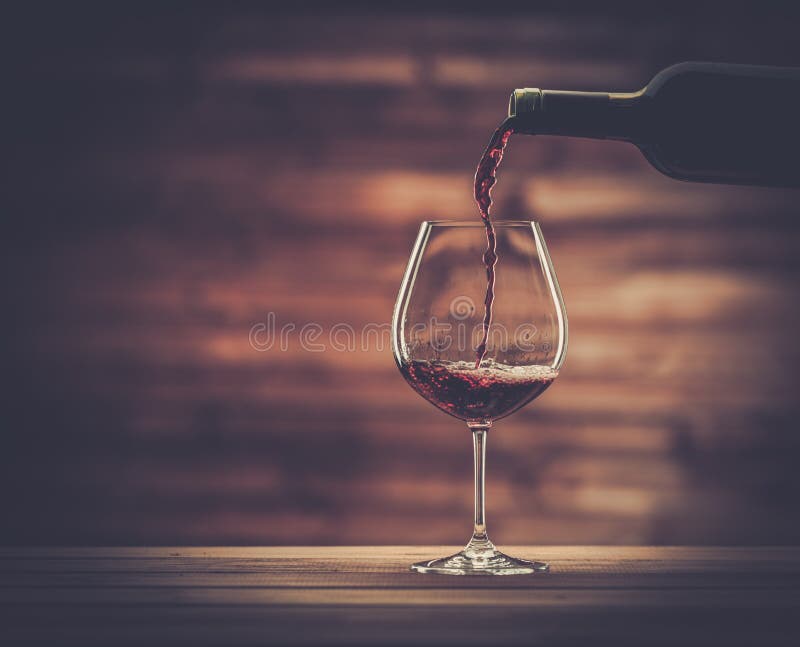 Pouring red wine into the glass