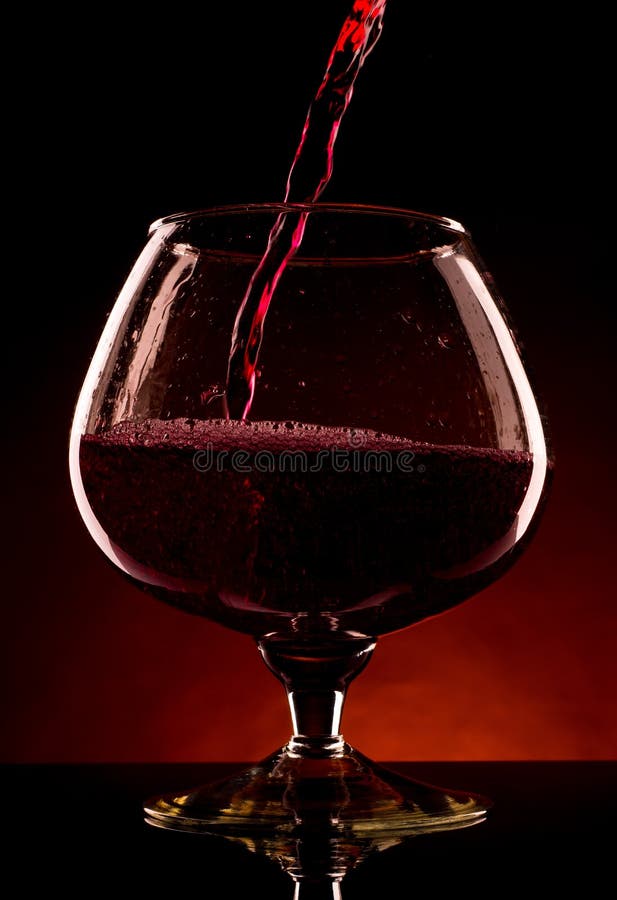 Pouring red wine into glass