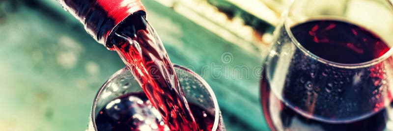 pouring red wine. Wine in a glass, selective focus, motion blur