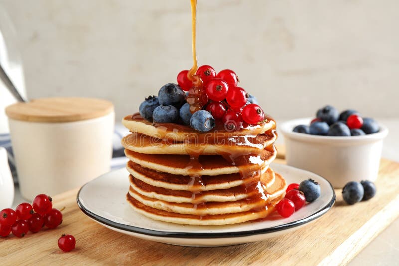 Pouring Syrup Onto Pancakes with Fresh Berries Stock Image Image of