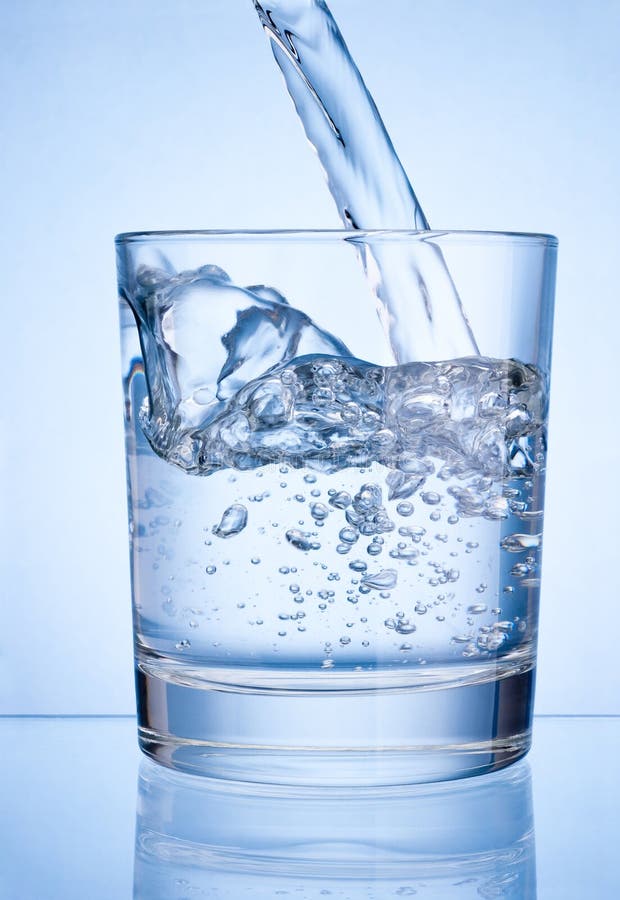 Pouring water into glass on blue background royalty free stock photography Pouring water into glass on blue background royalty free stock photography